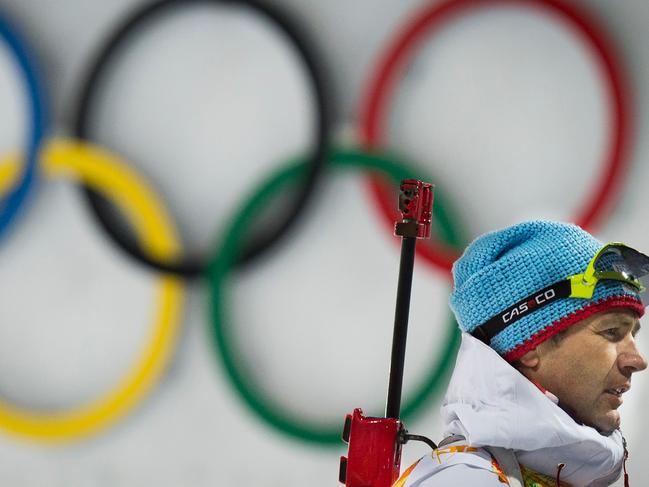 (FILES) This file photo taken on February 19, 2014 shows Norway's Ole Einar Bjoerndalen walking past the Olympic Rings after the Biathlon mixed 2x6 km + 2x7,5 km Relay at the Laura Cross-Country Ski and Biathlon Center during the Sochi Winter Olympics in Rosa Khutor near Sochi. Norway's biathlon superstar Ole Einar Bjorndalen, the most decorated male Winter Olympian in history, said on April 3, 2018 he would retire at the end of the season, at the age of 44.  / AFP PHOTO / ODD ANDERSEN