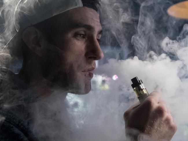 BRISTOL, ENGLAND - DECEMBER 30:  Mitchell Baker who works at the Vapour Place a vaping shop in Bedminster, exhales vapour produced by an e-cigarette on December 30, 2016 in Bristol, England. Recent figures released by the e-cigarette industry has claimed that there as many as 1700 vaping shops across the country, with two new ones opening each day catering for the estimated three million vapers in the UK. The popularity of e-cigarettes has boomed in the last ten years, as it is seen by many as a healthier alternative to traditional cigarettes, however some critics say the devices can carry the same risks as smoking especially as the long term affects are yet to be known.  (Photo by Matt Cardy/Getty Images)