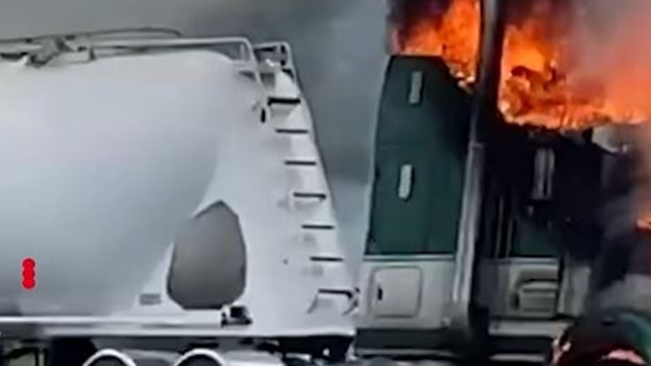 The truck cabin erupted in flames with the driver still inside the vehicle. Picture: Nine News