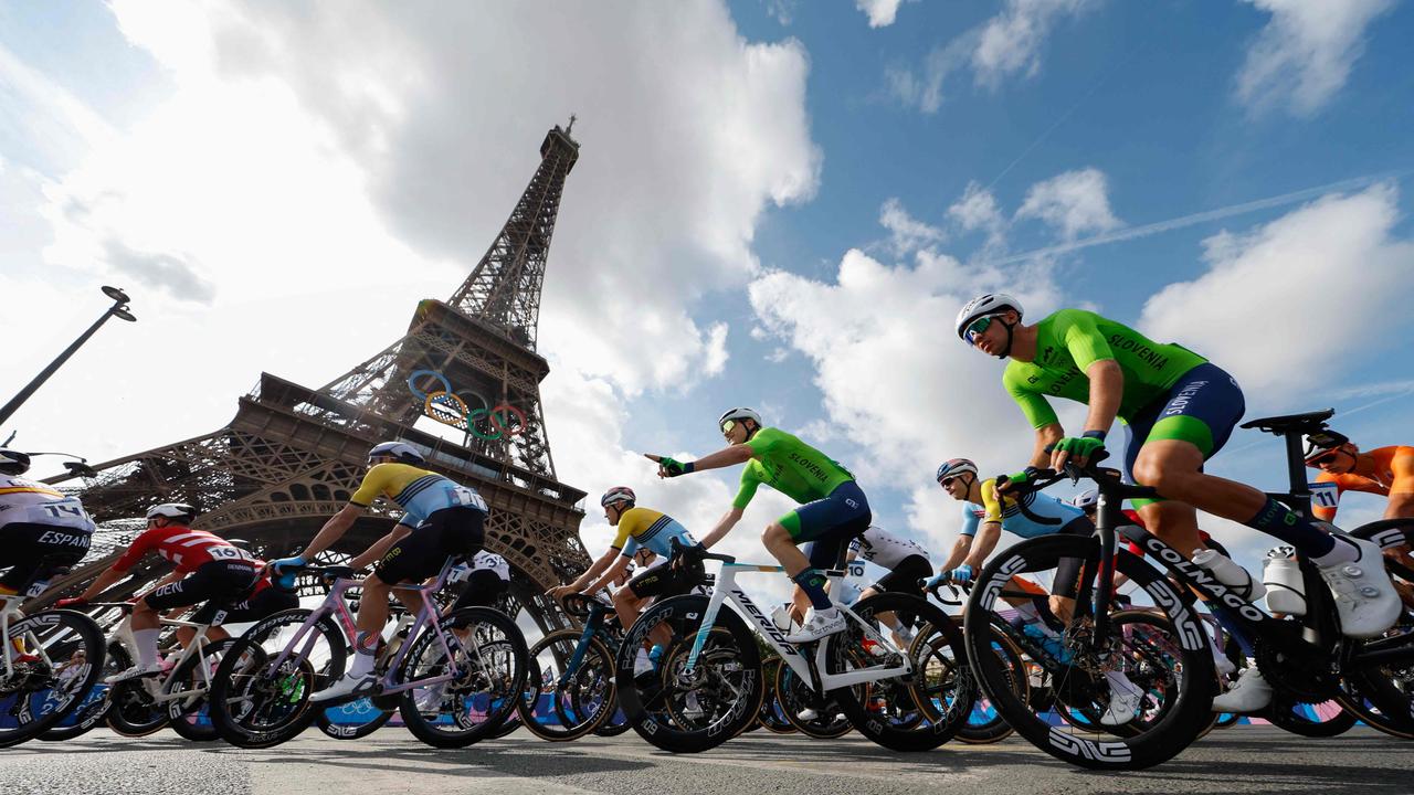 Cyclists pass the Eiffel Tower at the start of the men's cycling road race on August 3. Picture: Odd Andersen/AFP