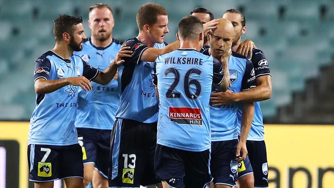 Sydney FC players celebrate with Adrian Mierzejewski after he scored a free-kick against Melbourne City.
