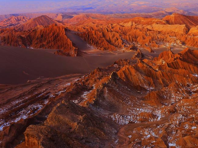 Atacama Desert Moon valley – Valle de La luna and Valle de La muerte – Death Valley – above dramatic ethereal pastel colored moon surface landscape at gold colored sunset, exotic volcanoes and Idyllic Atacama Desert, Volcanic landscape panorama – Chile, Bolivia and Argentina border