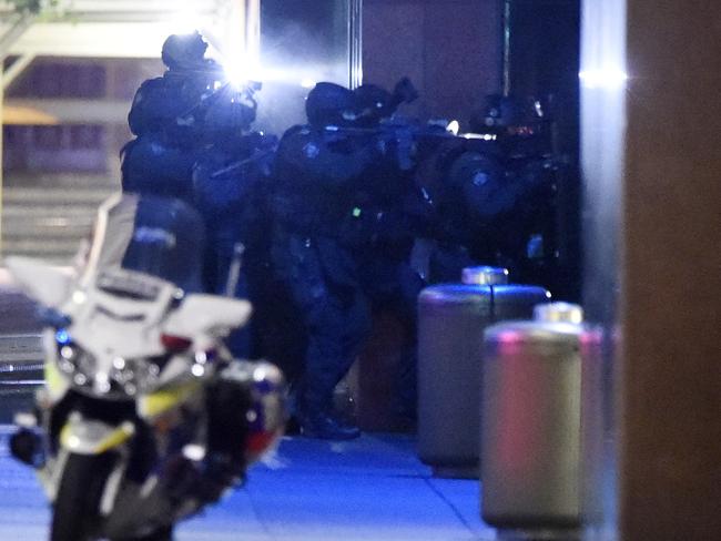 Police prepare to storm the Cafe. Picture: Gordon McComiskie