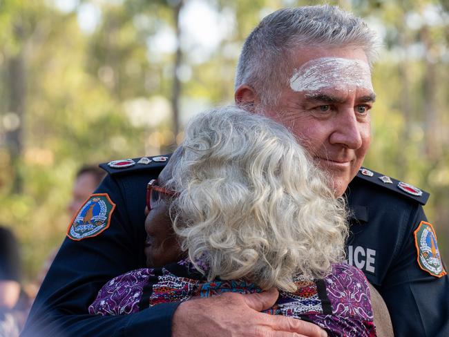 NT Police Commissioner Michael Murphy delivers an apology to First Nations people at Garma. He pledges to eliminate racism and is determined to improve relations between police and First Nations people.Murphy is pictured here embracing Djalinda Ulamari, a senior Yolngu woman who introduced Murphy to the crowd.Picture: Nina Franova / YYF