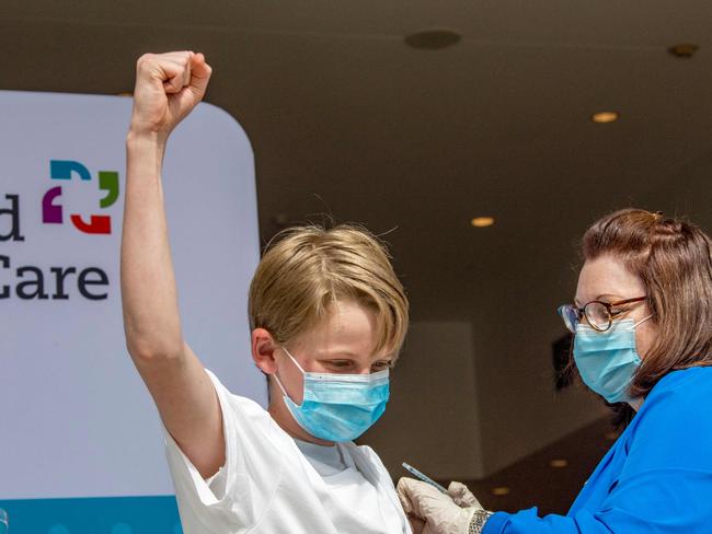 Charles Muro, age 13, celebrates being inoculated by Nurse Karen Pagliaro at a mass vaccination centre in Connecticut. Picture: AFP