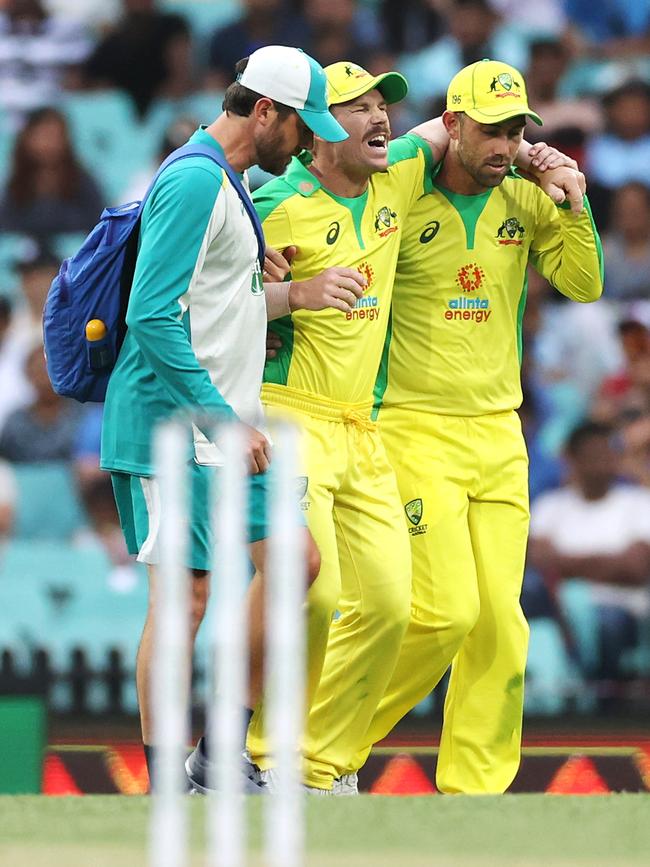 David Warner is helped from the field. Picture: Getty Images)