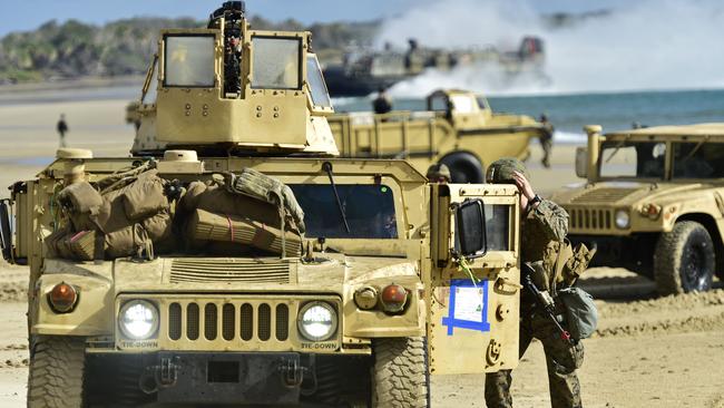 US Marines walk in front of a humvee fduring a military exercise. Picture AFP.