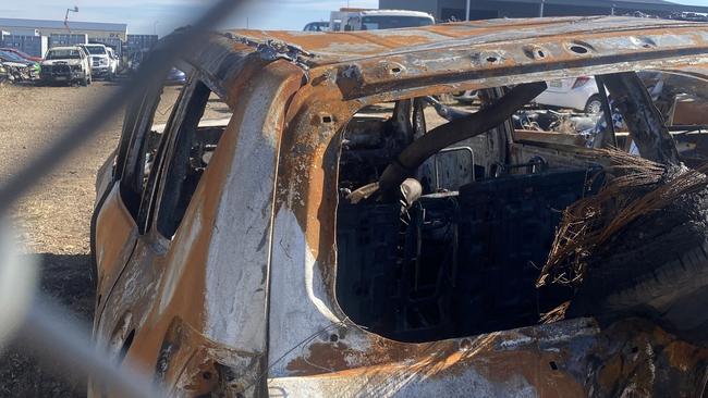 Two men have been charged withdestroying property by fire after allegedly torching nine cars in a storage facility.