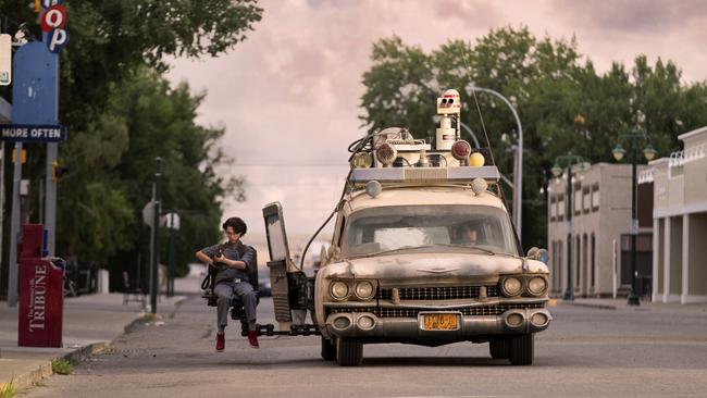 Phoebe (Mckenna Grace) in the Ecto-1 jumpseat in Ghostbusters: Afterlife