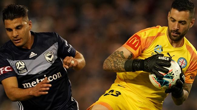 Melbourne City goalkeeper Dean Bouzanis claims the ball next to Melbourne Victory striker Andrew Nabbout. Picture: AAP