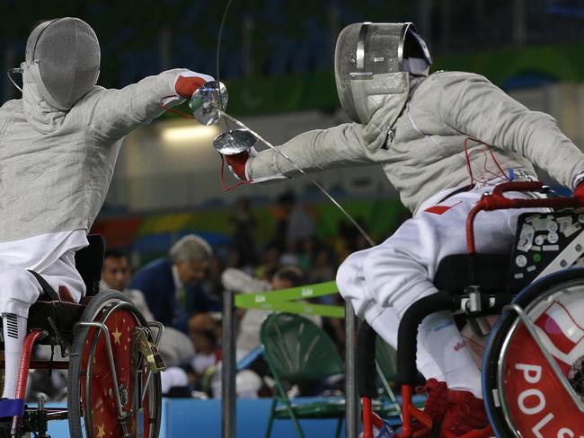 Yanke Feng, from China, left, competes with Adrian Castro, from Poland, in the men's individual sabre, category B, wheelchair fencing event at the Paralympic Games in Rio de Janeiro, Brazil, Monday, Sept. 12, 2016. (AP Photo/Leo Correa)