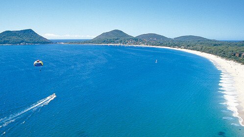 Shoal Bay Beach looking east. A three-metre shark was seen in the middle of the beach a day after a four-metre great white shark was reported to have “nudged” a jetski on the western end.