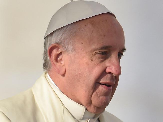 (FILES) Pope Francis brings a white rose to the Virgin Mary during his weekly general audience at St Peter's square on December 9, 2015 at the Vatican. Pope Francis 
