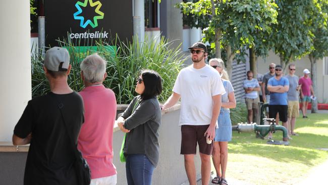 People queue outside Southport Centrelink in Queensland this week. Roy Morgan reports unemployment levels doubled in just a matter of days during March. Picture Glenn Hampson