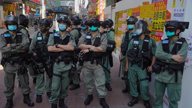 Police officers stand guard as people gather during a pro-democracy rally supporting human rights and to protest against Beijing's national security law in Hong Kong. Picture: AP