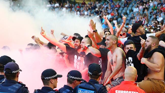 Wanderers fans in the crowd let off flares at Etihad Stadium