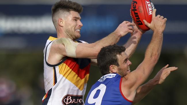 Jydon Neagle (right) competes for a mark against Adelaide’s Bryce Gibbs. He now plays for Balranald. AAP Image – Dean Martin