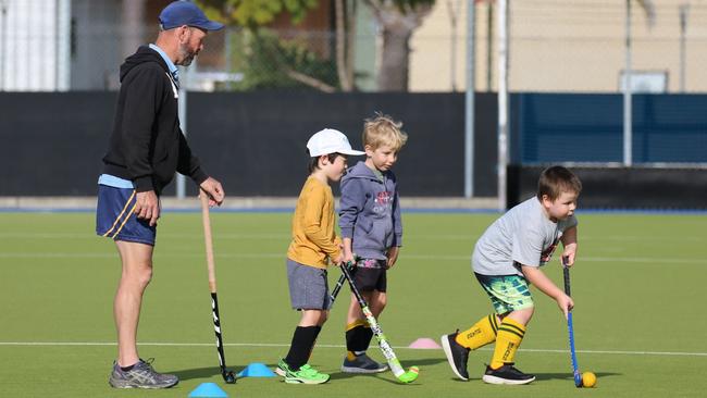 Rick Sampson leads the group during a school holiday hockey clinic at the Grafton fields on Thursday. Photo: Suellen Jenkins