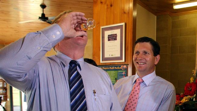 Opposition leader Lawrence Springborg watches Jeff Seeney down a Mulberry port at The Murdering Point Winery during the 2006 state election campaign.