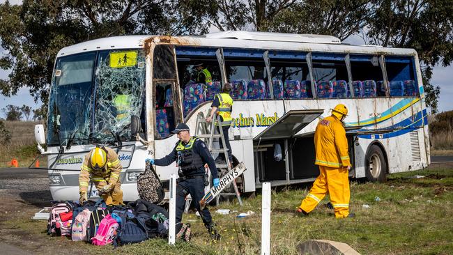 Police and crash site investigators remove schoolbags from the bus on Wednesday. Picture: Jake Nowakowski