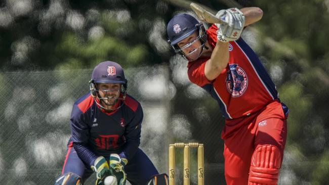 Dandenong keeper Jacques Augustin watches as Melbourne batsman Cameron White goes driving. Picture: Valeriu Campan