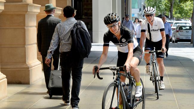 Adult cyclists can now legally use footpaths, but like these two, must give way to pedestrians.