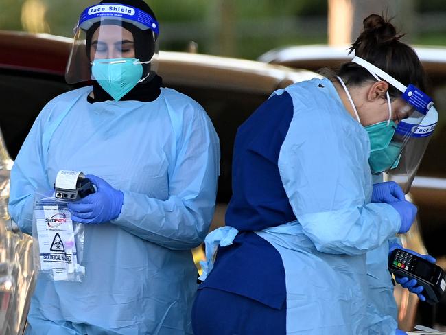 SYDNEY, AUSTRALIA - NewsWire Photos - JULY, 04, 2021: NSW Health workers dress in personal protection equipment (PPE) are seen at the Merrylands Park Drive-through Covid testing clinic in Sydney. New South Wales has recorded 16 new locally transmitted coronavirus cases overnight. Picture: NCA NewsWire/Bianca De Marchi