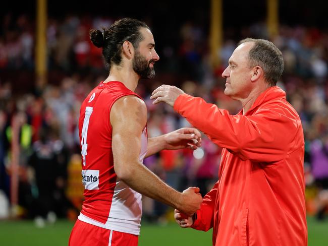 Brodie Grundy and coach John Longmire celebrate last week.