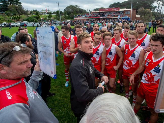 Coach Luke Tapscott gives instruction at the quarter time huddle. Picture: Jay Town