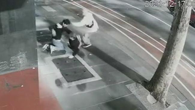 The moment father and son crime duo Jared Pihlgren, 53, and Jay Stephens, 23, launched a vicious assault on an innocent stranger on Lonsdale St, Melbourne, on December 17, 2021.