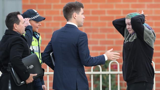 A distressed woman arrives at the scene where a man was stabbed to death in Hastings. Picture: David Crosling