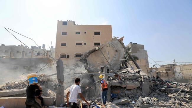 Palestinians survey the rubble of a collapsed building following an Israeli strike in Khan Yunis in the southern Gaza. Picture: AFP