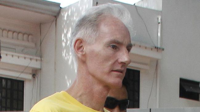 Peter Gerald Scully of Australia walks in handcuffs as he arrives at Cagayan de Oro city hall in southern Philippines on Tuesday, June 16, 2015. Scully and his Filipino girlfriend Carme Ann Alvarez have pleaded not guilty to charges of raping and trafficking two girls aged 9 and 12 in a southern Philippine city. Scully is also under investigation in the death of a girl whose remains were found inside his house in another southern province. (AP Photo)