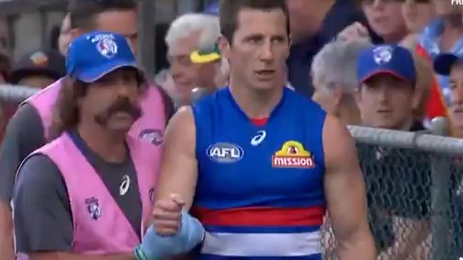 Dale Morris in the hands of the doctor after breaking his arm against the Suns. Picture: Supplied