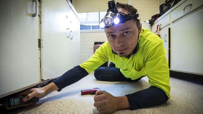 Martin Bohata from Healthy Homes Tasmania doing a mould test on a public housing unit in South Hobart. Picture: LUKE BOWDEN