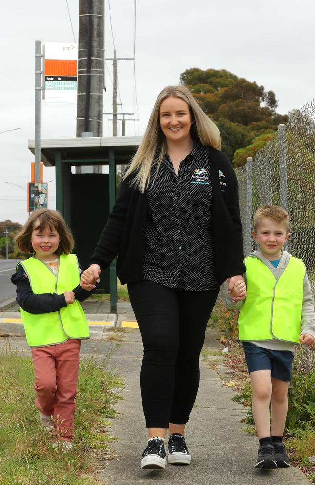 Ms Kiel, pictured with five-year-old students River and Emmeline at the bus stop, said the street kinder program empowered them. Picture: Alison Wynd