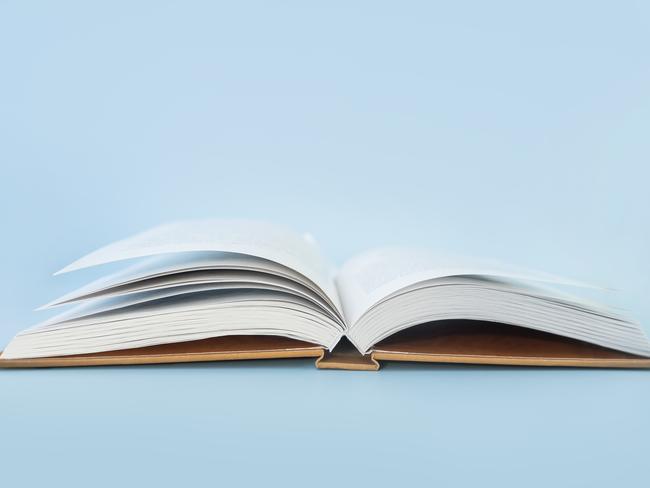 Open book of blank pages on a blue background. copy space