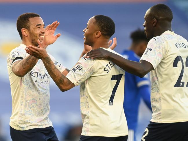 LEICESTER, ENGLAND - APRIL 03: Gabriel Jesus of Manchester City celebrates with team mates Raheem Sterling and Benjamin Mendy after scoring their side's second goal during the Premier League match between Leicester City and Manchester City at The King Power Stadium on April 03, 2021 in Leicester, England. Sporting stadiums around the UK remain under strict restrictions due to the Coronavirus Pandemic as Government social distancing laws prohibit fans inside venues resulting in games being played behind closed doors. (Photo by Michael Regan/Getty Images)