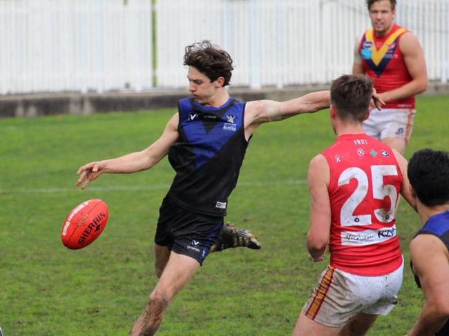 Henry Bennett gets a kick away for University Blacks in the VAFA. Picture: Facebook