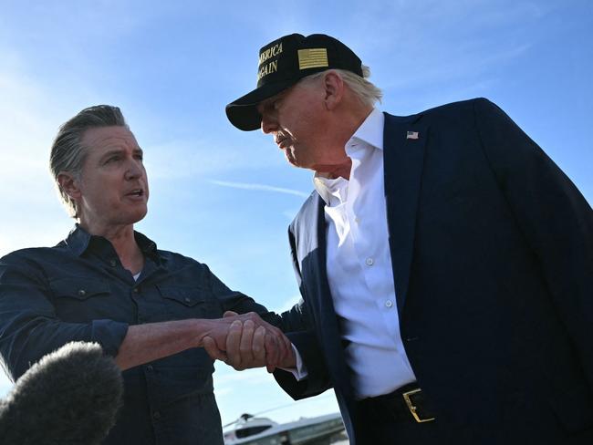 Mr Trump shakes hands with the Democratic Governor as he speaks to the press upon arrival at Los Angeles International Airport. Picture: Mandel Ngan / AFP