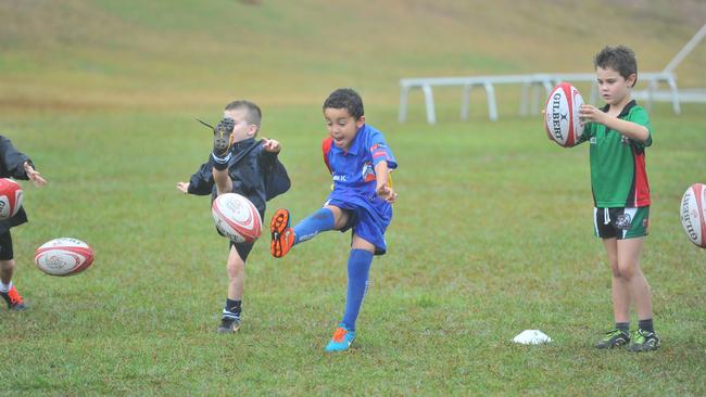 A young Noah Mariner, 5, playing rugby union in a clinic run by Queensland Reds player Lolo Fakaosilea and QRU coach Ken Dobson back in 2015.