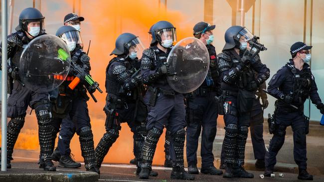 Police have bottles and flares throw towards them during the CFMEU protest. Picture: Getty