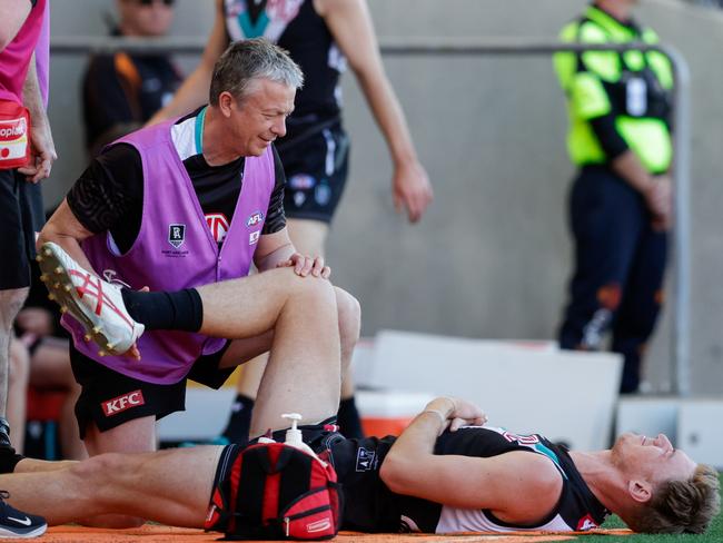 Todd Marshall in pain after a clash with teammate Charlie Dixon. Picture: Getty Images