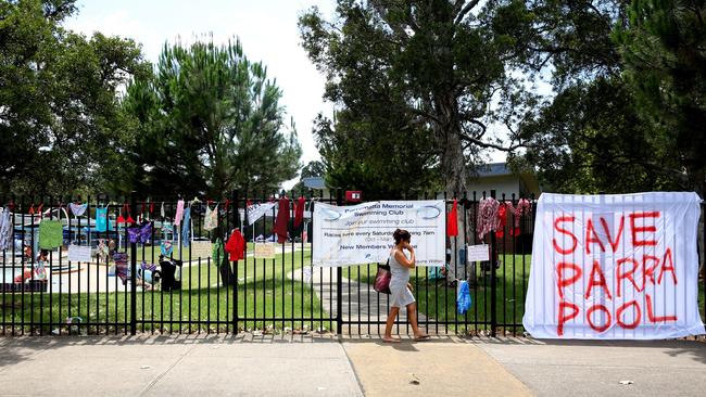 Swimming suits hang from the fence around Parramatta pool. Picture: Peter Kelly