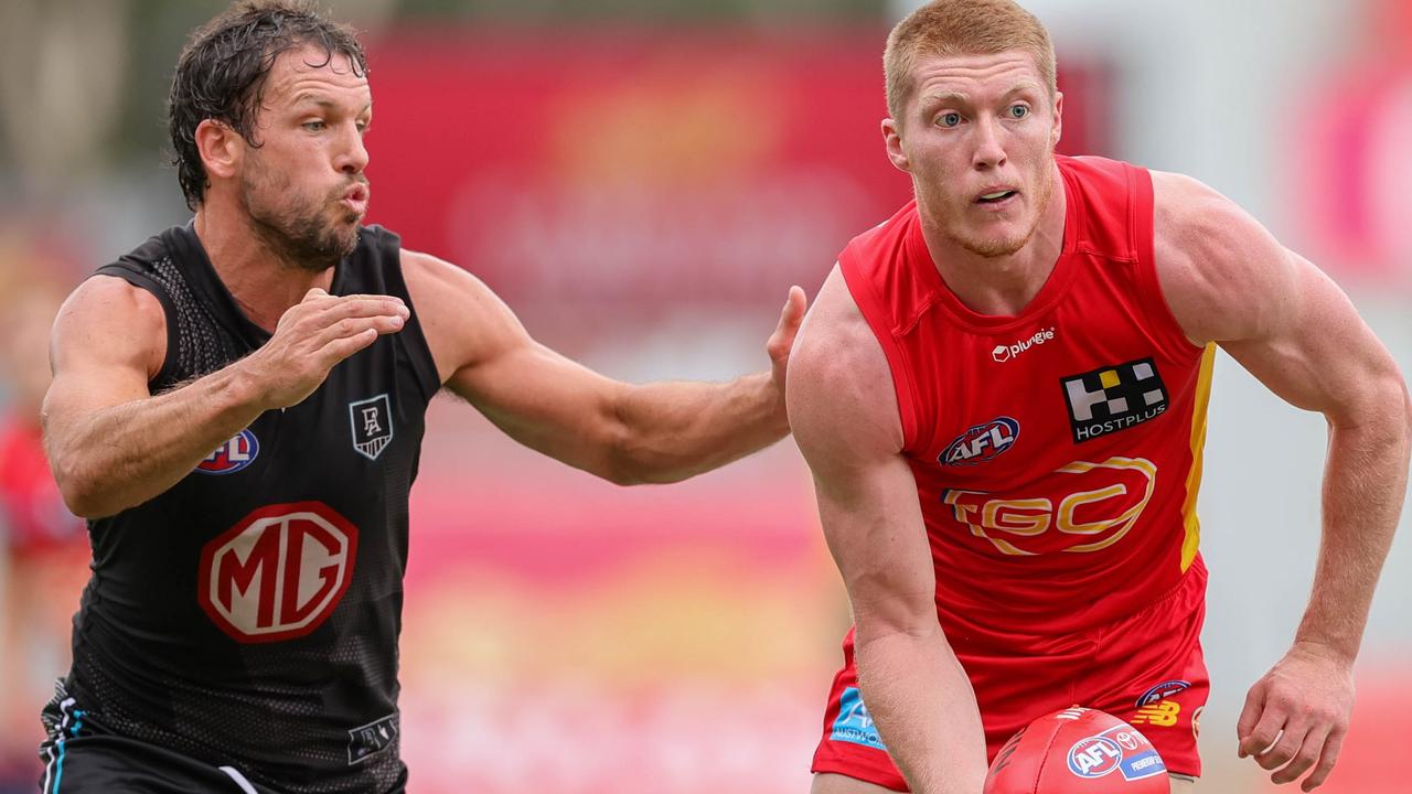 Gold Coast’s Matt Rowell gets a handball away under pressure from Port Adelaide’s Travis Boak. Picture: Russell Freeman/AFL Photos