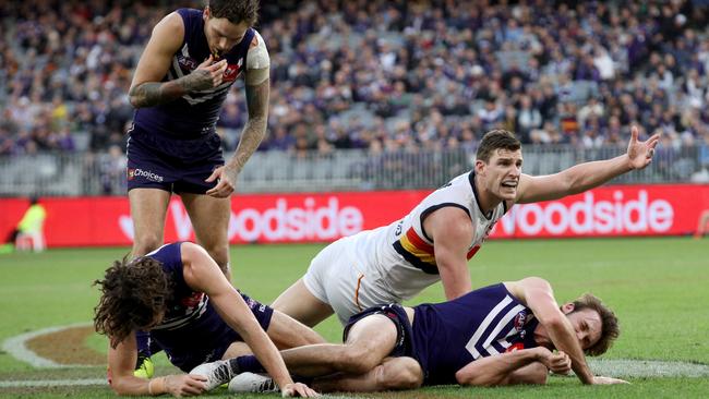 Dockers Alex Pearce (left) and Joel Hamling stunned after a tackle with Adel;aide’s Josh Jenkins at Optus Stadium in Perth. Picure: Richard Wainwright/AAP