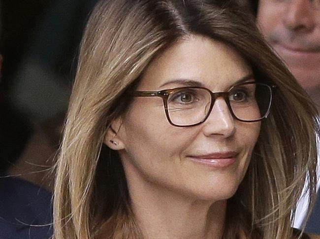 FILE - In this April 3, 2019, file photo, actress Lori Loughlin, front, and her husband, clothing designer Mossimo Giannulli, left, depart federal court in Boston after a hearing in a nationwide college admissions bribery scandal. On Thursday, May 21, 2020, the U.S. Attorney's Office in Boston said Loughlin and Giannulli have agreed to plead guilty to charges of trying to secure the fraudulent admission of their two children to the University of Southern California as purported athletic recruits. (AP Photo/Steven Senne, File)