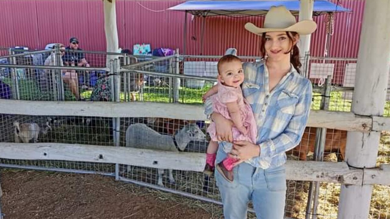 Sophia Holland and daughter Flicka who is on her way to joining the family run miniature goat stud. Photo: Sophia Holland