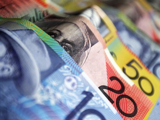 Australian banknotes in various denominations are arranged for a photograph in Sydney, Australia, on Monday, May 24, 2010. The Australian and New Zealand currencies slid for the sixth time in seven days against the U.S. dollar on concern Europe's debt crisis will spread. Photographer: Ian Waldie/Bloomberg