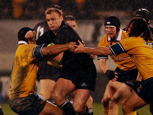 NEW ZEALAND - JULY 13: All Black Scott Robertson breaks through the Wallabies defence in the TriNations rugby match at Jade Stadium, Christchurch, Saturday. The All Blacks won 126. (Photo by Ross Land/Getty Images)